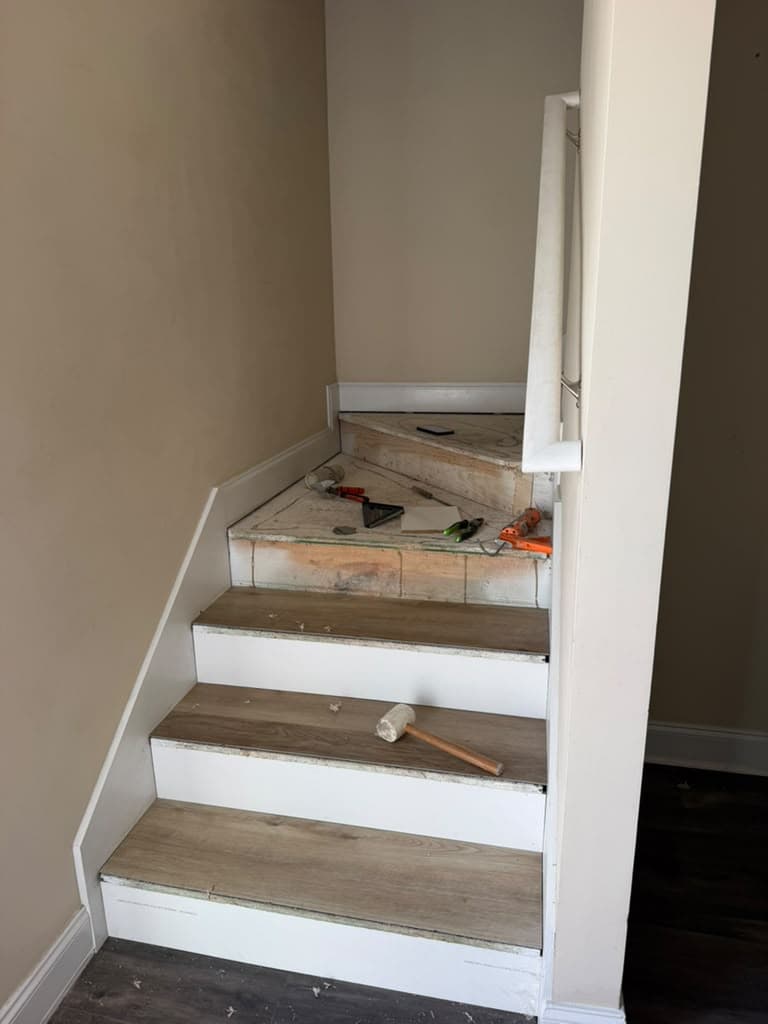 Staircase during renovation with old tile winder steps